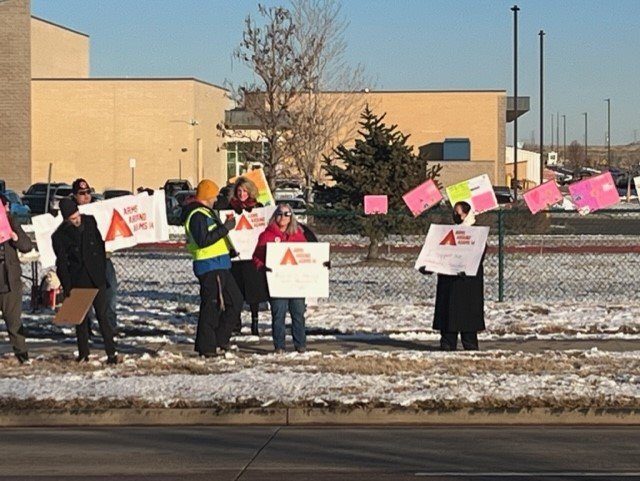 Teachers and others rally outside Adams City High School Nov. 18 to protest the state board of education's decision to reorganize the district.