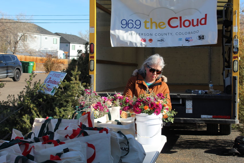 Rosemary DeHoyos, a volunteer from Ramos Law, helps organize supplies during the Nov. 22 Dignity Tuesday event at Golden's New Hope Community Church. About 25 local organizations and businesses partnered to give away 100 Thanksgiving meals and Christmas trees outside the BGoldN food pantry.