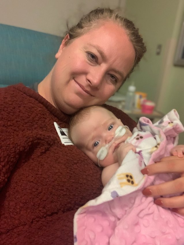 Brianne Price holds her daughter, Lily, who was hospitalized with a virus commonly known as RSV in November.