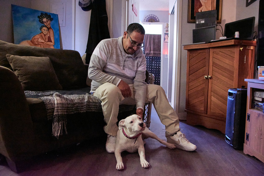 David Hernandez pays government-subsidized rent for his one-bedroom apartment, where he lives with his dog.