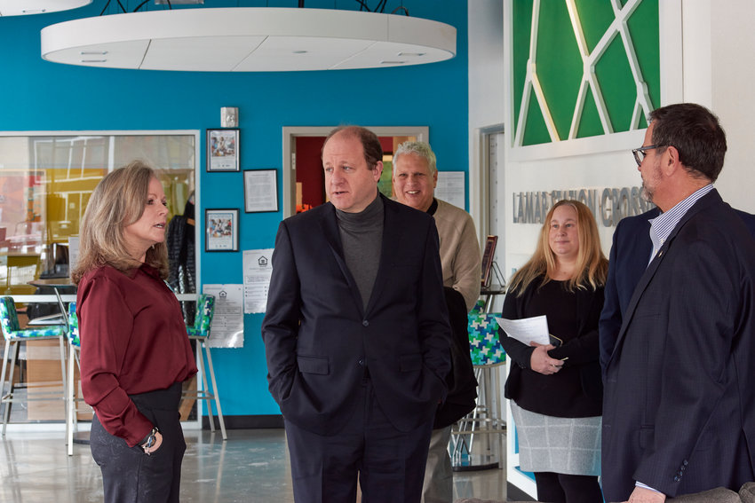 Gov. Jared Polis (center), along with Metro West Housing Solutions CEO Tami Fischer (left) and Lakewood Mayor Adam Paul (right), visited Lamar Station Crossing, a MWHS apartment complex with some affordable units. MWHS offers housing vouchers along with human services.