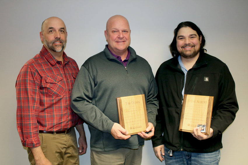 Highlands Ranch Metro District facilities employees and award recipients Tim Doan and Steve Albert pose with Construction &amp; Facilities Maintenance Manager Ken Standen after being honored on Jan. 31 for rescuing a woman who fell into a frozen pond.