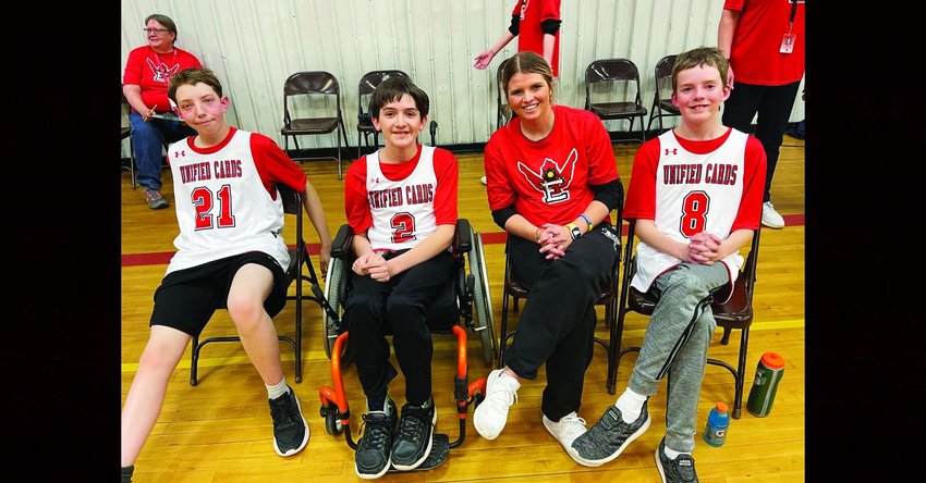Three players sit with a player mentor at the Second Annual Unified Basketball Game on Feb. 22 at Elizabeth Middle School. The players are, from left: Davis Savage, Kelvin Kaufman and Cole Martens.