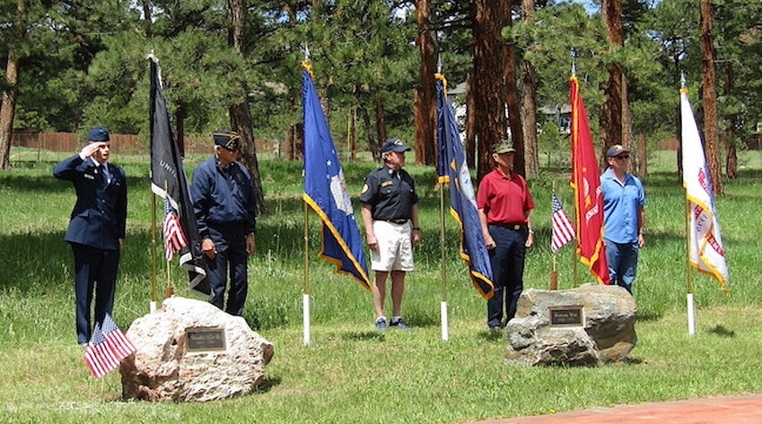 Second Lt. Jackson Lindquist of Evergreen, left, places and salutes the U.S. Space Force flag at the Memorial Day commemoration at the Buchanan Park veterans memorial on May 29. Each branch of the military was honored.