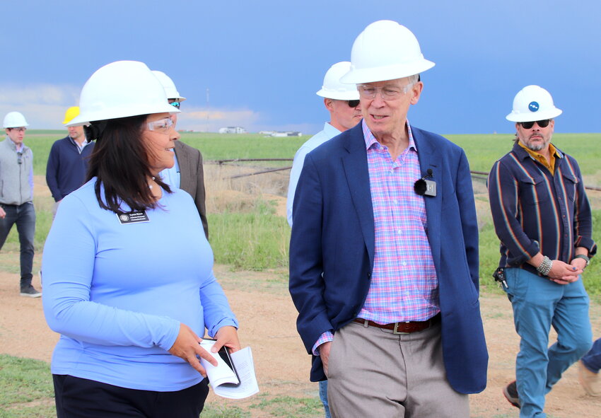 U.S. Sen. John Hickenlooper chats with Adams County Commissioner Lynn Baca May 25 at an abandoned oil drilling site in unincorporated Adams County.