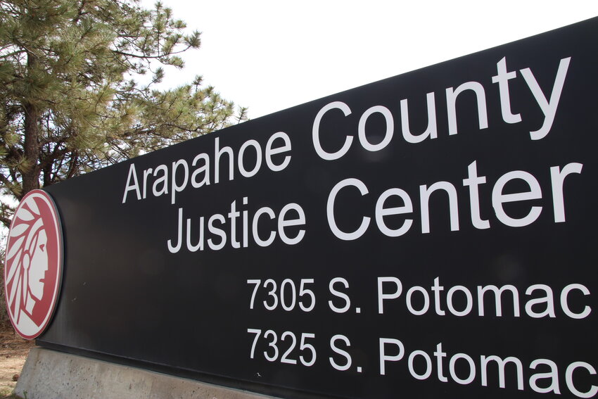 A sign stands at the Arapahoe County Justice Center in May.