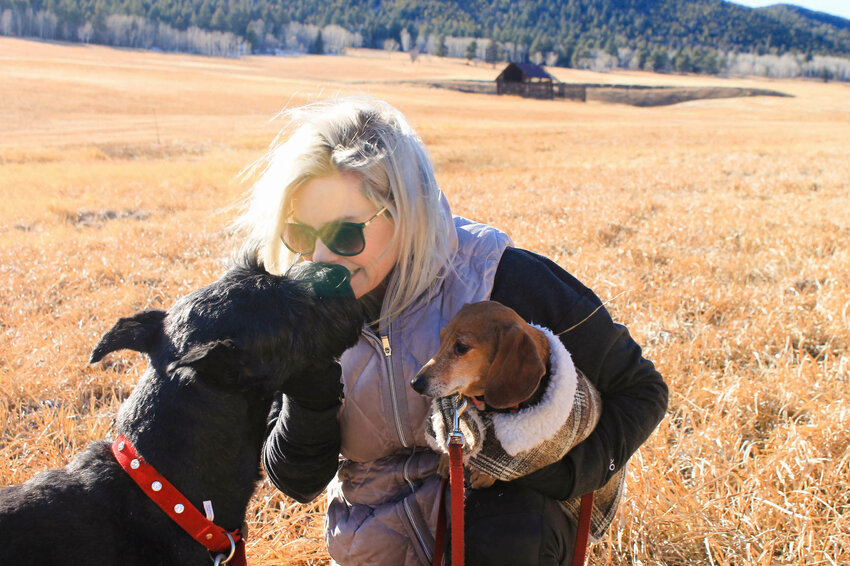 Lori Marcin with her dogs, Gigi the giant schnauzer, and Oliver the dachshund, in Elk Meadow.