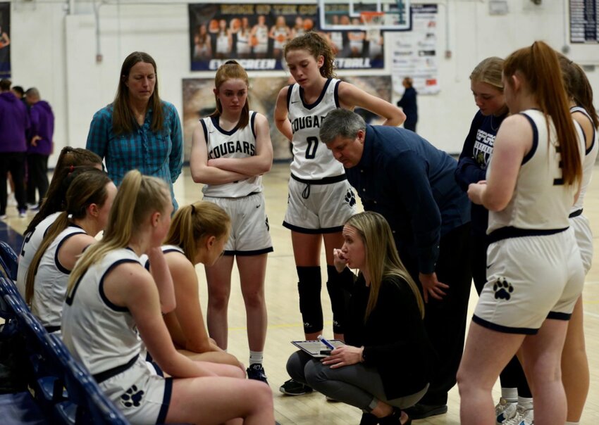 Maddy Hornecker (middle, crouched) was the head basketball coach of Evergreen High School before becoming the school's athletic director. Together, Hornecker helped lead the Cougars to back-to-back state titles in 2017 and 2018 / Courtesy Photo