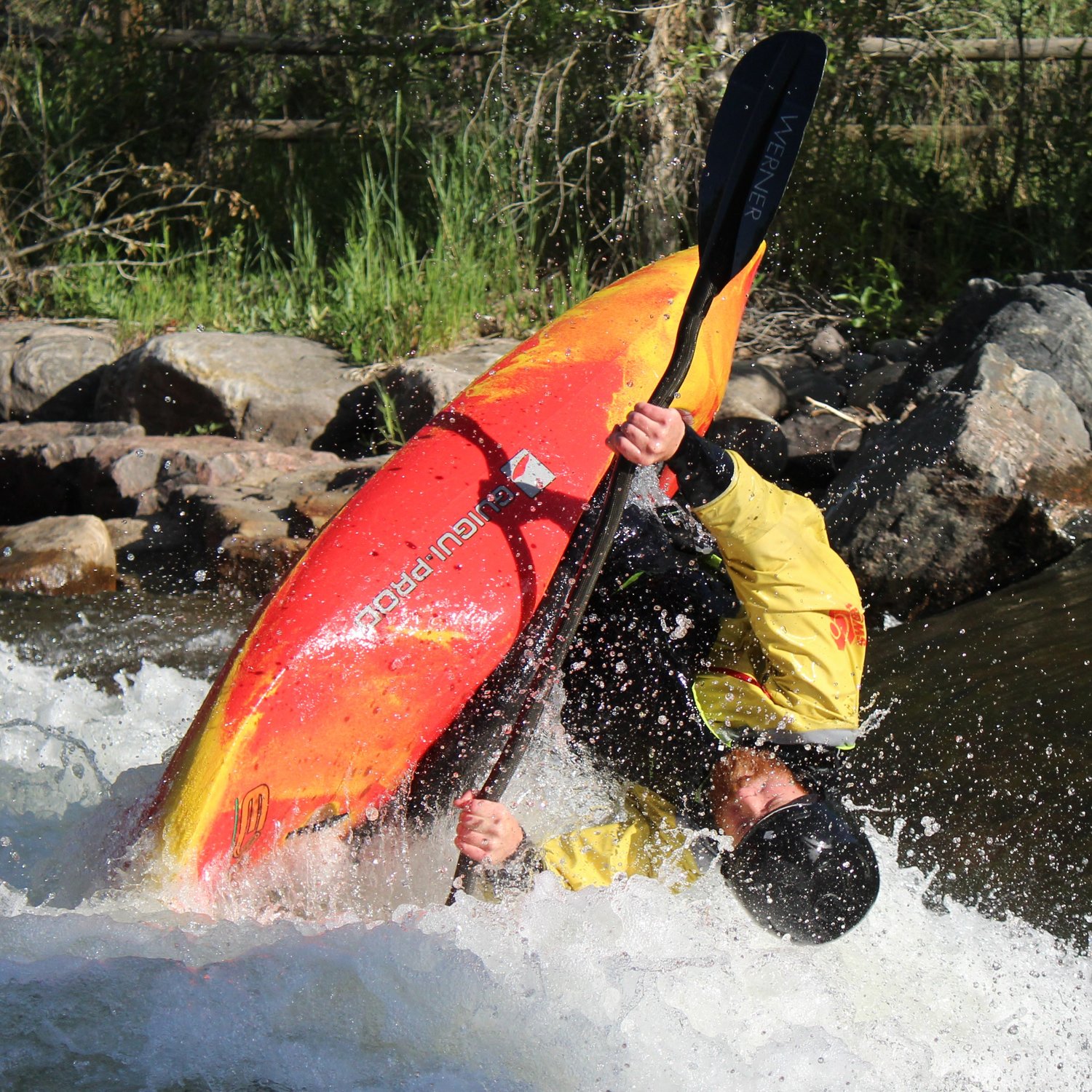 Aran Kilroy executes a flipping maneuver during the June 22 Kayak Rodeo at Clear Creek Whitewater Park.