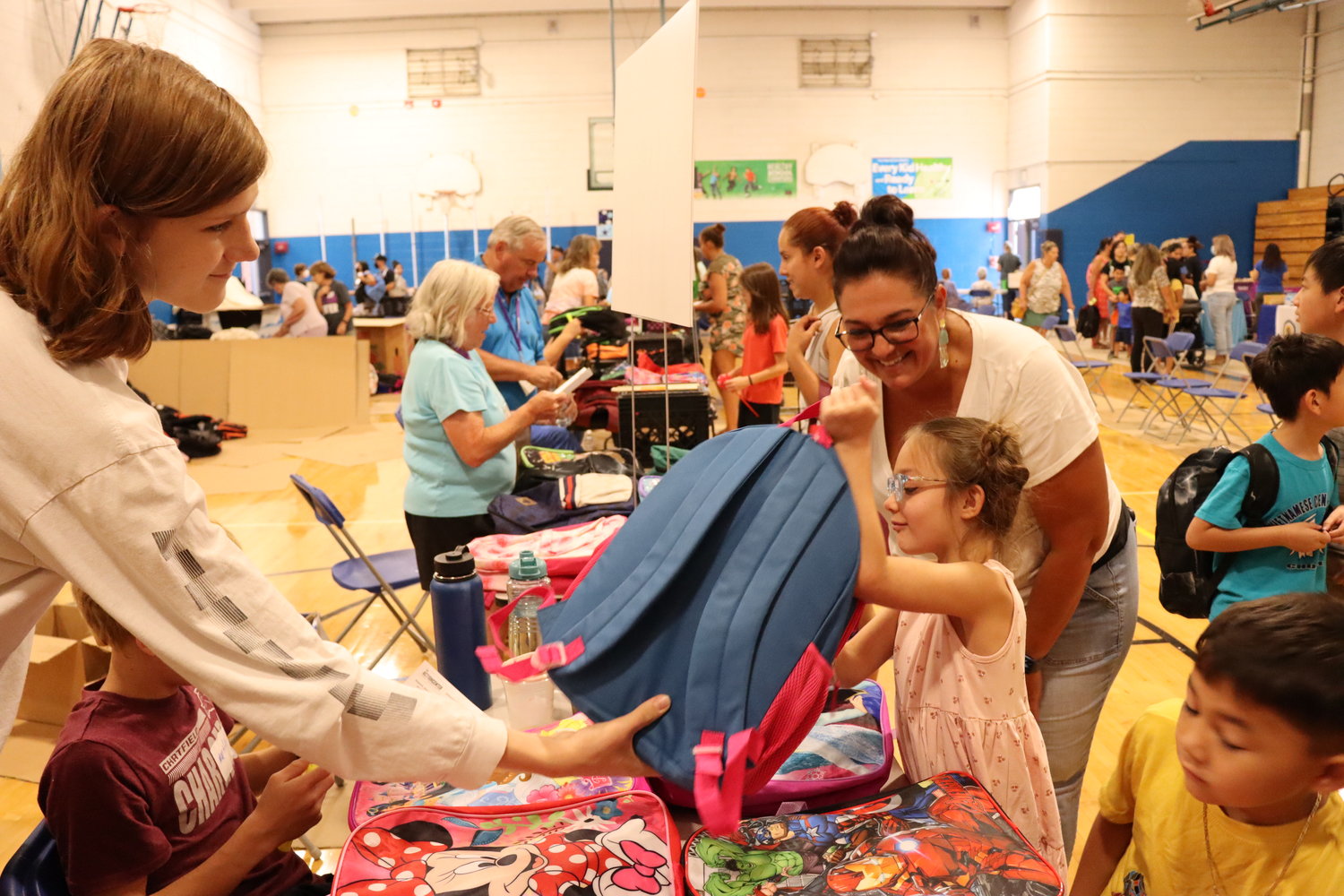 Volunteers and community members come together at the annual school supply distribution event hosted by the Action Center. This year's event was held at Everitt Middle School in Wheat Ridge.