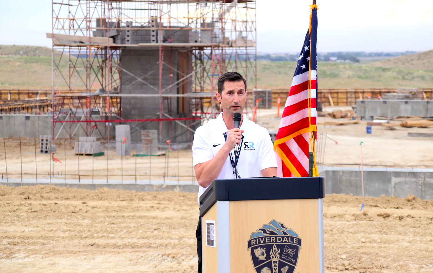 Riverdale Ridge High School Principal Cody Clark, standing with the school's new STEM addition behind him, welcomes students, parents and city, county and school district officials to the groundbreaking ceremony at the school on Sept. 14.