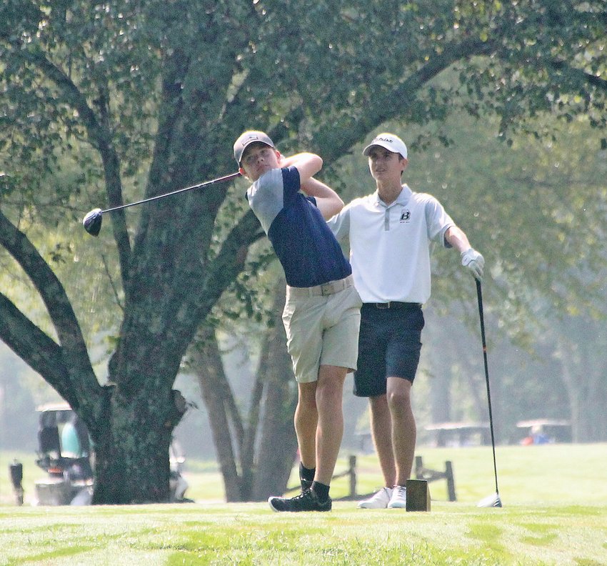 WALKER VALLEY junior Ian Kinsey fires a drive off the seventh tee at the Cleveland Country Club Monday, leading the Mustangs to a second place finish in the 7th annual Don Burke Memorial/Bradley Invitational. Bradley Central junior Jonas Rayfield awaits his turn to hit. Kinsey's broke par for the first time with a 1-under-par 71.