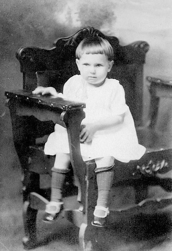 LITTLE RUTH McCRACKEN wore overalls mostly on the farm, but her parents got her to sit straight up in her dress for a photograph.
