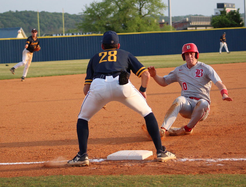 MUSTANGS THIRD BASEMAN Landon Franklin (28) waits on the relay throw from shortstop Preston Hodges as Baylor runner Carson Yates slides into the bag in the first inning Monday, at Mike Turner Field.