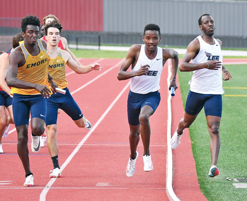 FLAMES' RUNNER Titus Lagat, center, begins the third leg of the 4x400-meter relay after receiving the baton from teammate Jeremiah McCain at the Last Chance Meet Saturday, at Lee University.
