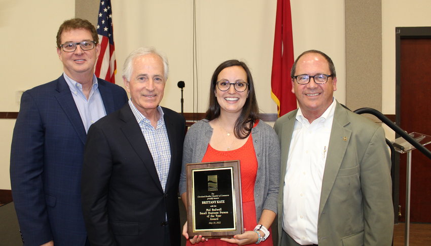 BRITTANY KATZ holds a plaque honoring her as the Mel Bedwell Small Businessperson of the Year during a Cleveland/Bradley Chamber of Commerce awards luncheon held Wednesday, May 18, at the Museum Center at 5ive Points. From left are Brad Benton, last year's recipient; former U.S. Sen. Bob Corker; Katz; and Chamber President and CEO Michael Griffin.
