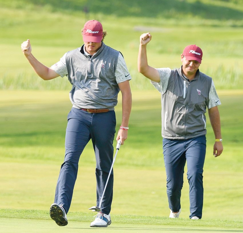FLAMES GOLFER Connor Pollman, left,  and assistant coach Evan Spence celebrate after Pollman rolled in a birdie on 18 to win his match at the national semifinals Thursday, in Detroit, Mich.