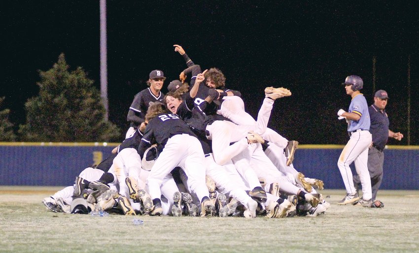 BRADLEY CENTRAL players celebrate with a dog-pile after claiming the Region 3-4A Championship Game with a 5-3 win over Walker Valley Wednesday evening, at Mike Turner Field.