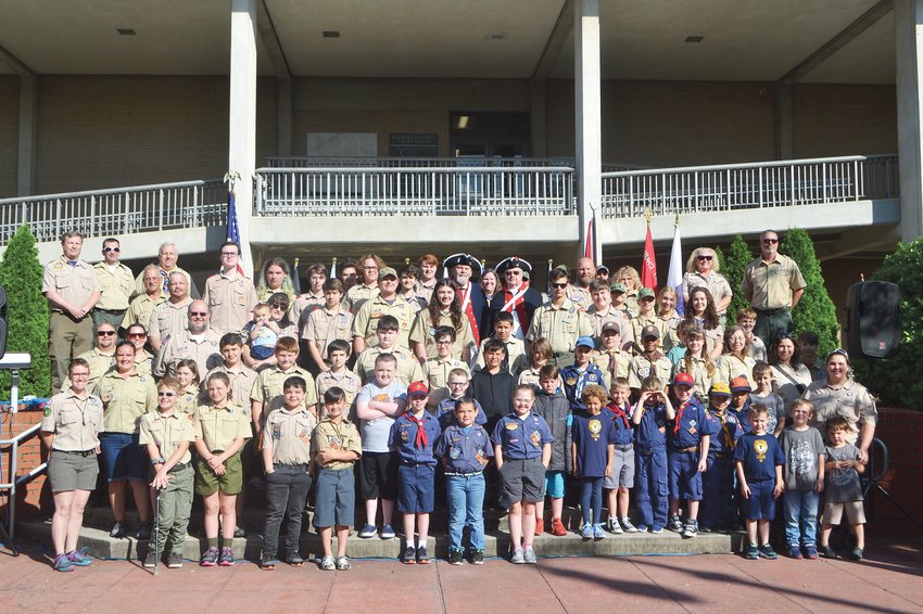 AREA SCOUTS GATHERED at the Bradley County Courthouse for a brief ceremony Saturday before heading out to local cemeteries to place American flags at the headstones of Armed Forces veterans. The event is a tradition for the scouts each year for Memorial Day.