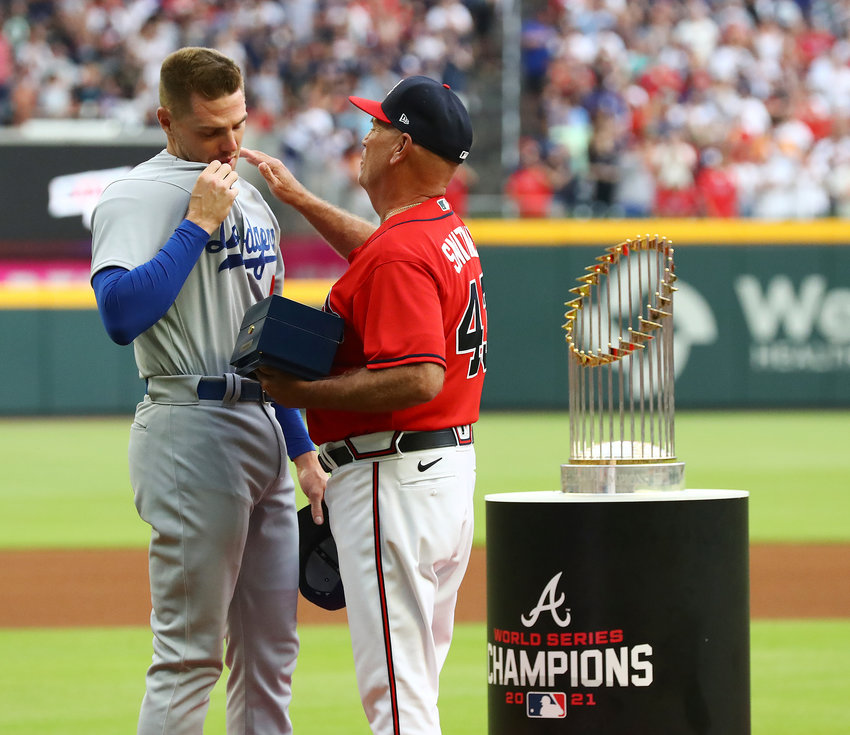 ATLANTA BRAVES manager Brian Snitker, right, presents former Braves first baseman Freddie Freeman with his World Series Championship ring during Freeman's return to Atlanta with the Los Angles Dodgers Friday, at Truist Park.