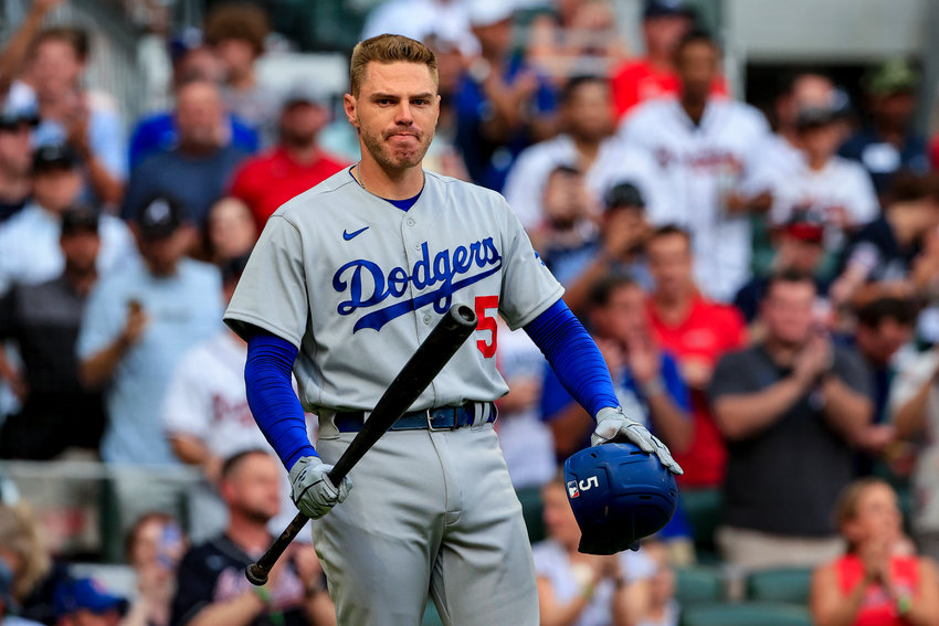 LOS ANGELES Dodgers' Freddie Freeman reacts to a standing ovation by the Atlanta Braves fans as he steps up to bat during the first inning of Fridya evening's game at Truist Park.