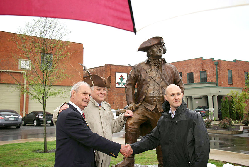 The statue of Col. Benjamin Cleveland was unveiled at a special state and chapter meeting on April 18, 2013. From left are fundraising Chairman Phil Newman, chapter President Judge Van Deacon and sculptor Josh Coleman.