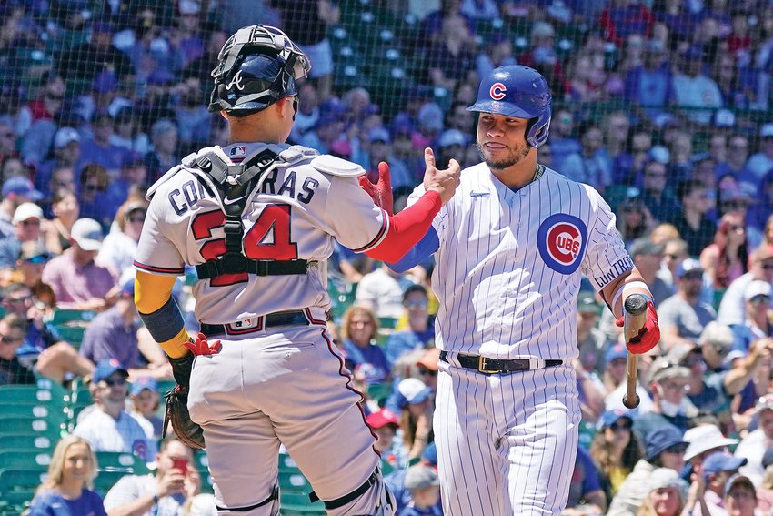 CHICAGO CUBS' Willson Contreras, right, greets his brother Atlanta Braves catcher William Contreras Saturday. The duo is the fifth siblings to start in a  MLB All Star Game.