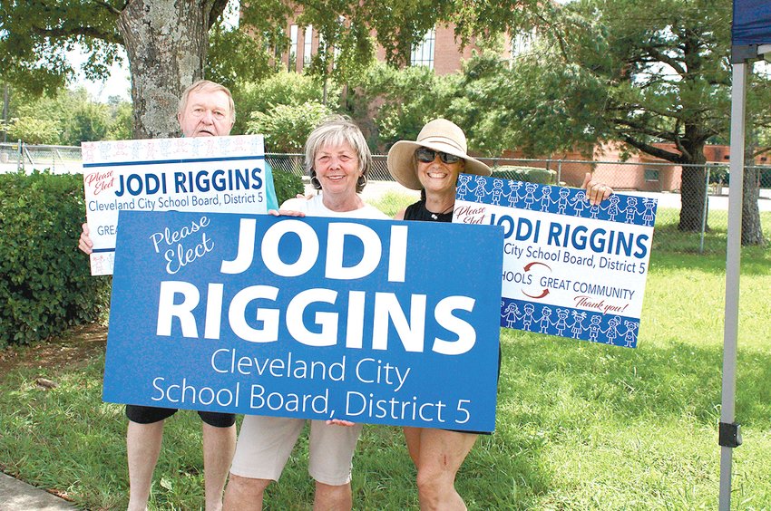 Jodi Riggins (center) stood across from CHS, waving and holding signs, for hours on Election Day.