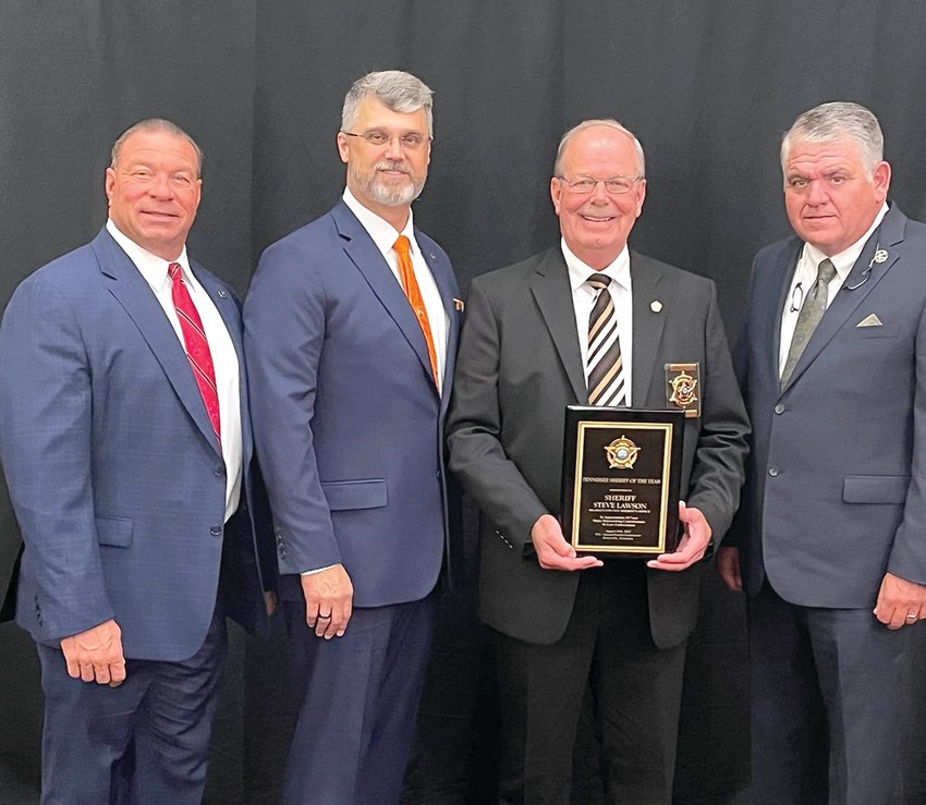 Putnam County Sheriff Eddie Farris, from left, Executive Director of Tennessee Sheriff's Association Jeff Bledsoe, Bradley County Sheriff Steve Lawson and current association President and Wilson County Sheriff Robert Bryan pose with the Tennessee &quot;Sheriff of the Year&quot; award.