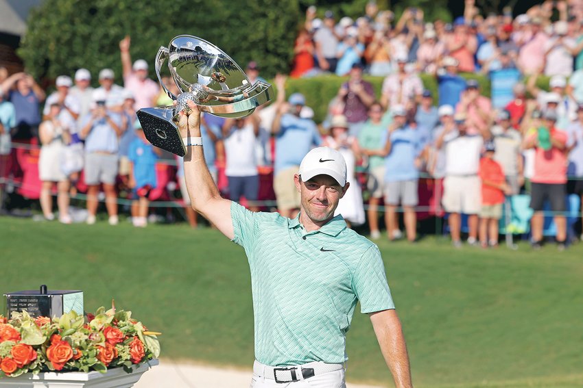 Rory McIlroy celebrates with the trophy after winning the Tour Championship at East Lake Golf Club Sunday in Atlanta.