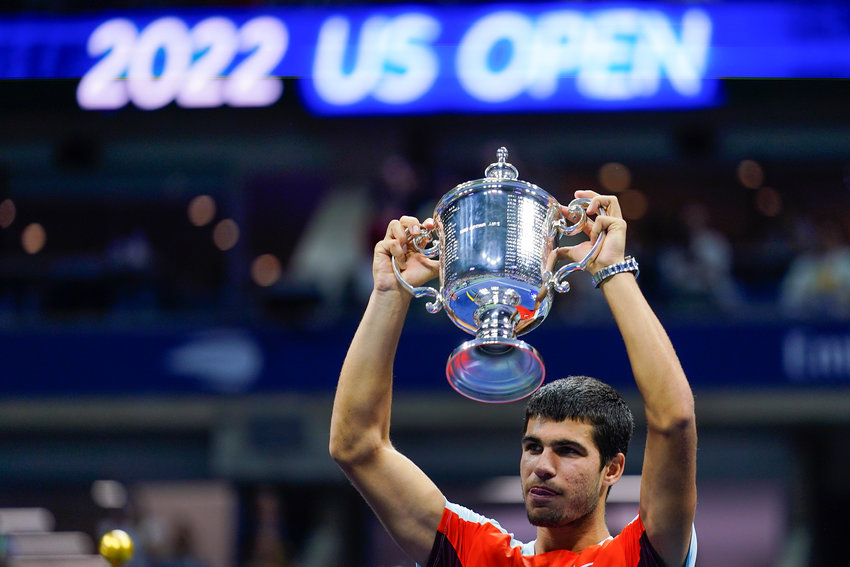 CARLOS ALCARAZ, of Spain, holds up the championship trophy after defeating Casper Ruud, of Norway, in the men's singles final of the U.S. Open tennis championships Sunday in New York.