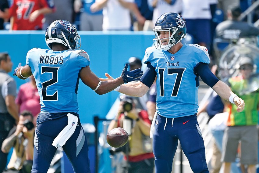 TENNESSEE TITANS quarterback Ryan Tannehill (17) celebrates with Robert Woods (2) after Tannehill ran for a touchdown against the Las Vegas Raiders in the first half Sunday in Nashville.