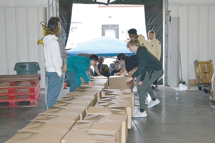VOLUNTEERS help distribute food boxes at last year's William Hall Rodgers event at Tri-State Warehouse.