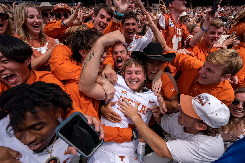 TEXAS QB Quinn Ewers (3) celebrates with fans after his team's 49-0 win over Oklahoma in an NCAA college football game at the Cotton Bowl, Saturday, Oct. 8, 2022, in Dallas.