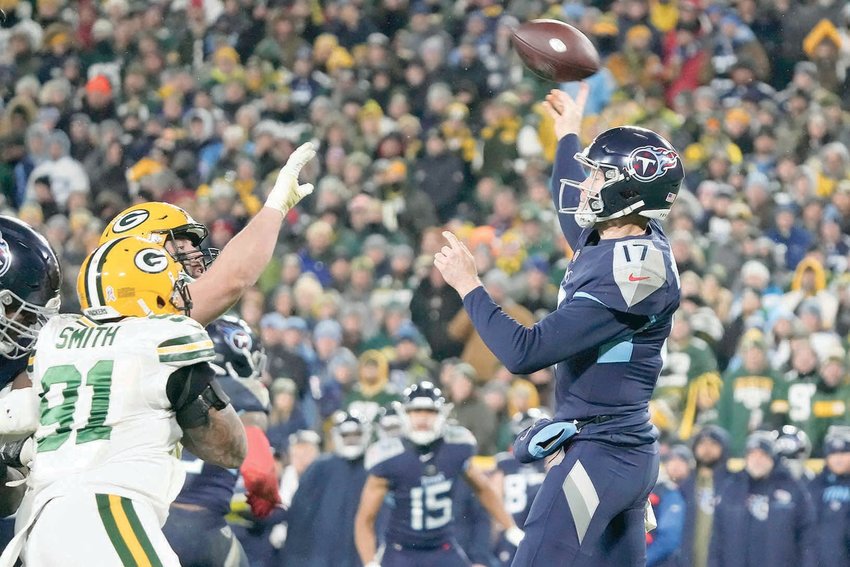 TENNESSEE TITANS QB Ryan Tannehill (17) throws a pass under pressure from Green Bay Packers linebacker Preston Smith (91) during the second half of Thursday's NFL victory, in Green Bay, Wis.