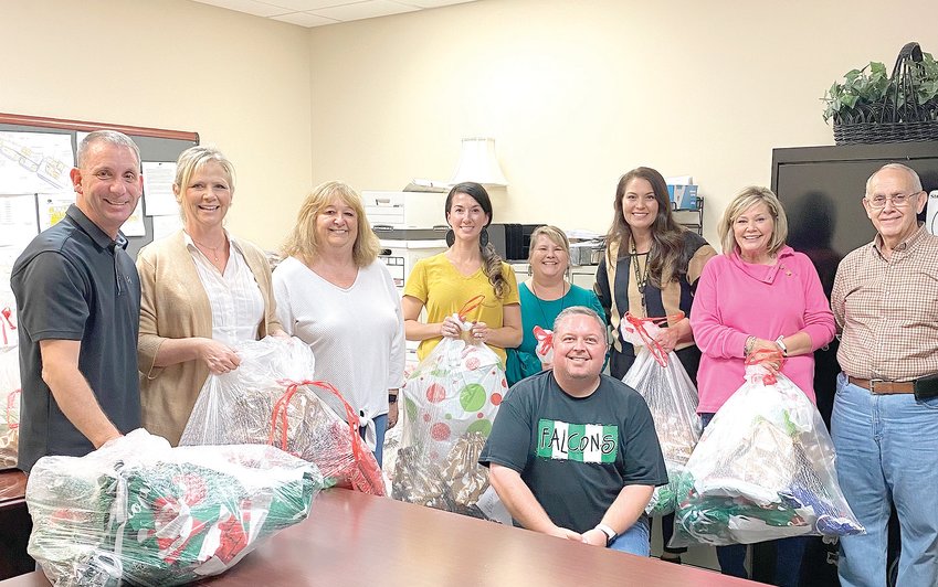 BCS PRINCIPALS gather to pack Christmas gifts for the Empty Stocking Fund. From left are Steve Montgomery, Jodie Grannan, Brenda Lawson, Heather Hayes, Erica Shamblin, Amber Winters, Ruthie Panni, Eddie Moreland and Brad Davis.
