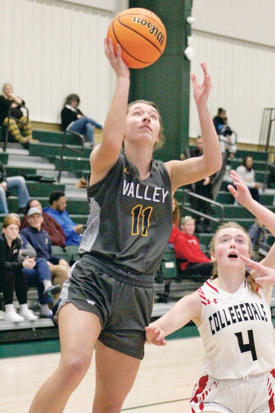WALKER VALLEY girls' basketball's Madison Bischof (11) goes up for a basket over Collegedale's Claire Fisher in the second quarter at Silverdale Baptist Academy Monday evening. Bischof and the Lady Mustangs defeated the Lady Eagles 73-24, earning their first win of the 2022-23 season in the process.
