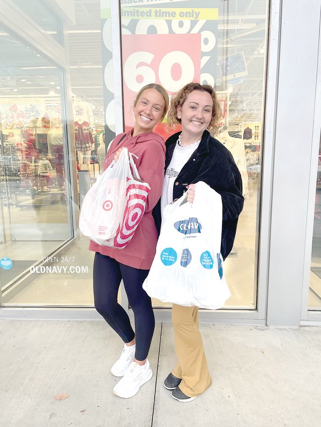 EMILY WOODEN, left, and Olivia Savee, show off purchases they made Friday morning, Nov. 25, at Old Navy and Target.