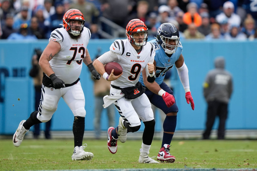 Cincinnati Bengals quarterback Joe Burrow (9) runs out of the pocket against the Tennessee Titans during the first half Sunday in Nashville.