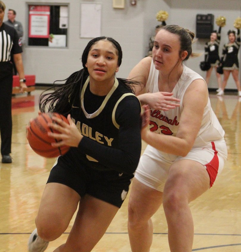 KIMORA FIELDS fights through traffic on the way to the basket in the first quarter of Tuesday's District 5-4A game at Ooltewah. Fields had 22 points on the way to the Bearettes' 87-33 win over the Lady Owls.