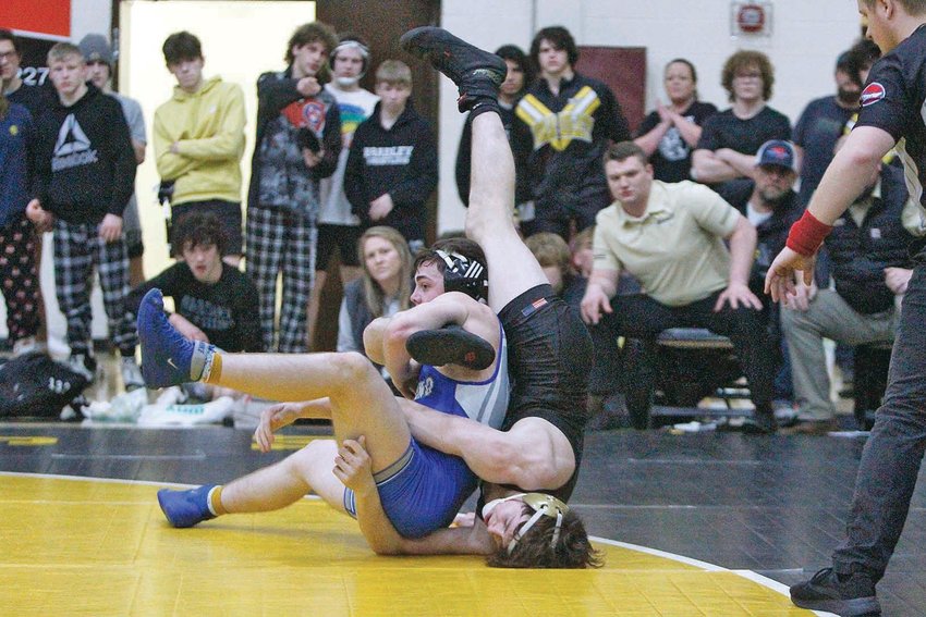 IN A STATE-RANKED battle, Cleveland's No. 4 Cy Fowler, left, and fifth-ranked Bradley Gunner Taylor tangle in the 160-pound match. Taylor took the 6-3 decision, but the Blue Raiders claimed their sixth straight Region Duals title by a slim 31-30 margin, in Athens.