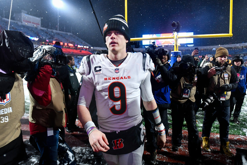 Cincinnati Bengals quarterback Joe Burrow (9) walks off the field after the Bengals beat the Buffalo Bills 27-10 in the NFL division round Sunday in Orchard Park, N.Y.