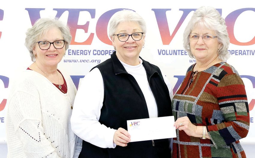 VEC POLK COUNTY Customers Share Board Member Barbara Randolph (right) presents a check to Donna Hall (left) and Teresa Yates (middle), representatives of the Polk County High School Alumni Association.