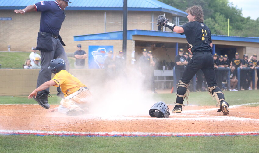 WALKER VALLEY junior Felix Castellanos gets by the tag attempt of the McMinn County catcher,  causing the umpire to get some air as he emphatically call him safe on the very close play during Saturday's District 5-4A semifinal series, at Bill Talley Stadium.