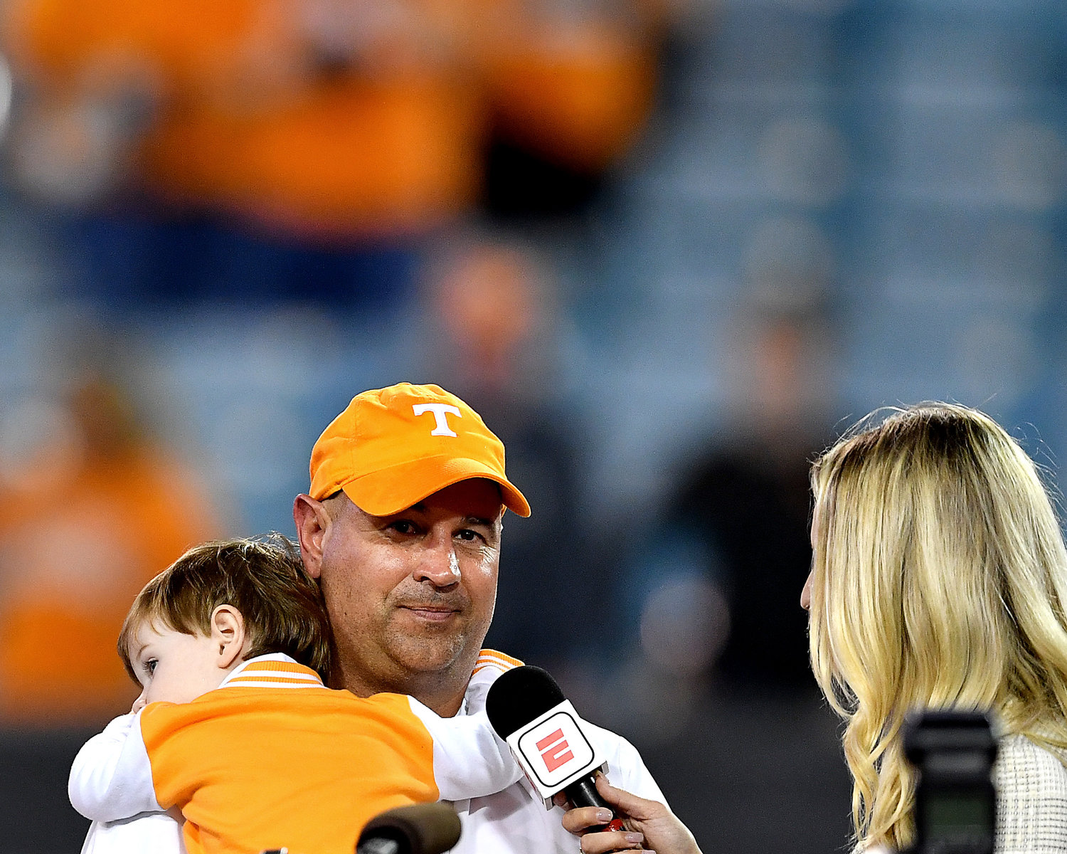 Tennessee Volunteers head coach Jeremy Pruitt speaks with an ESPN reporter while his son rests on his shoulder following the Vols win over the Indiana Hoosiers at the Gator Bowl Thursday, January 2, 2020, at TIAA Bank Field in Jacksonville, Fla.