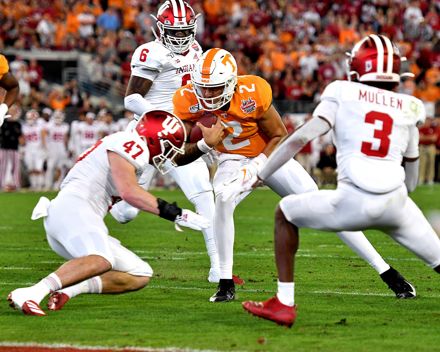 Tennessee Volunteers quarterback Jarrett Guarantano (2) drops a shoulder on a keeper in the first half of the Gator Bowl NCAA football game against the Indiana Hoosiers Thursday, January 2, 2020, at TIAA Bank Field in Jacksonville, Fla.
