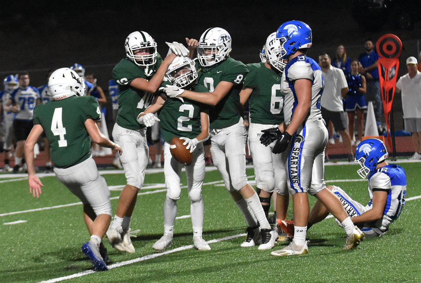Defensive back Braxton Lewis (2) is congratulated by teammates following an interception in the game on Friday, Sept. 9.