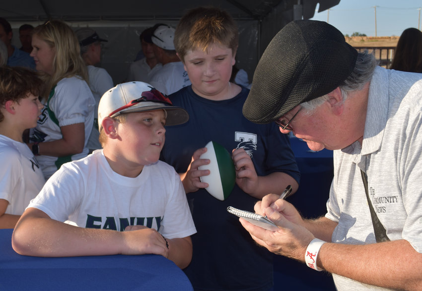 Rick Mauch of The Community News interviews TCA fourth-graders Jace Shaw and Jackson Presley.