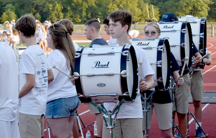 Ethan Withrow and Tegan Pace take their places with the drum line.