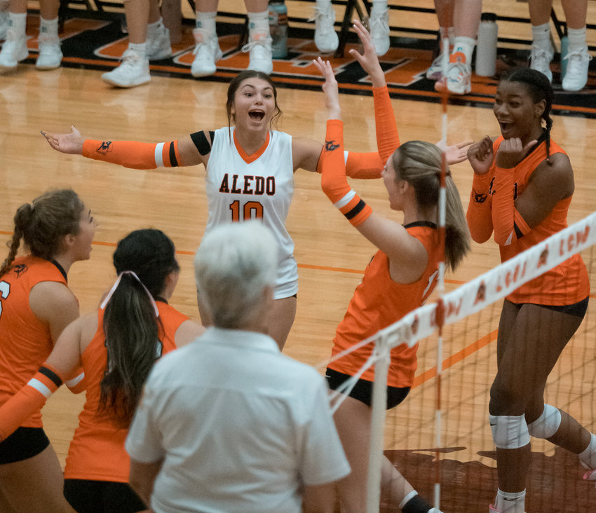 Mia Little celebrates with teammates after a play.